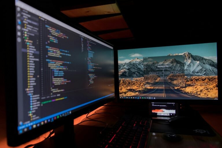 Two computer monitors at a development workspace
