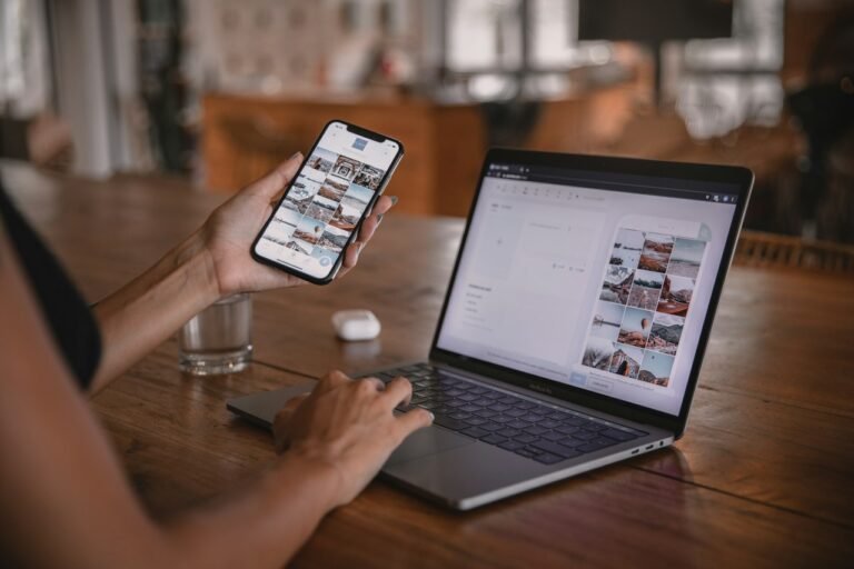 Person using a laptop and smartphone at a desk