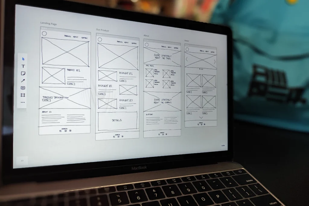 Website wireframes displayed on a laptop