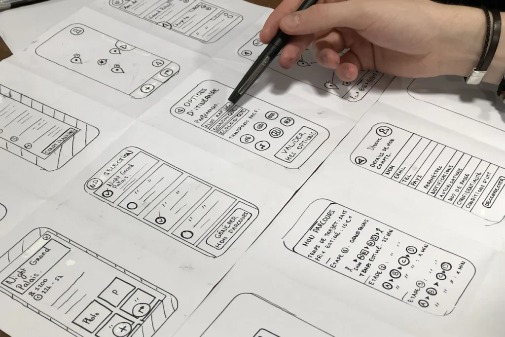 Wireframe sketches reviewed with a pen
