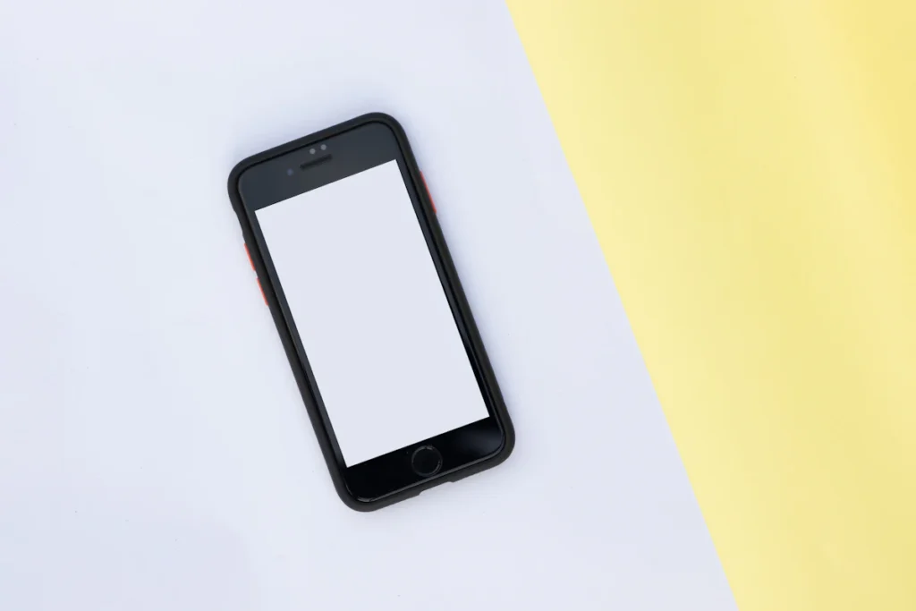 A smartphone with a blank screen on paper