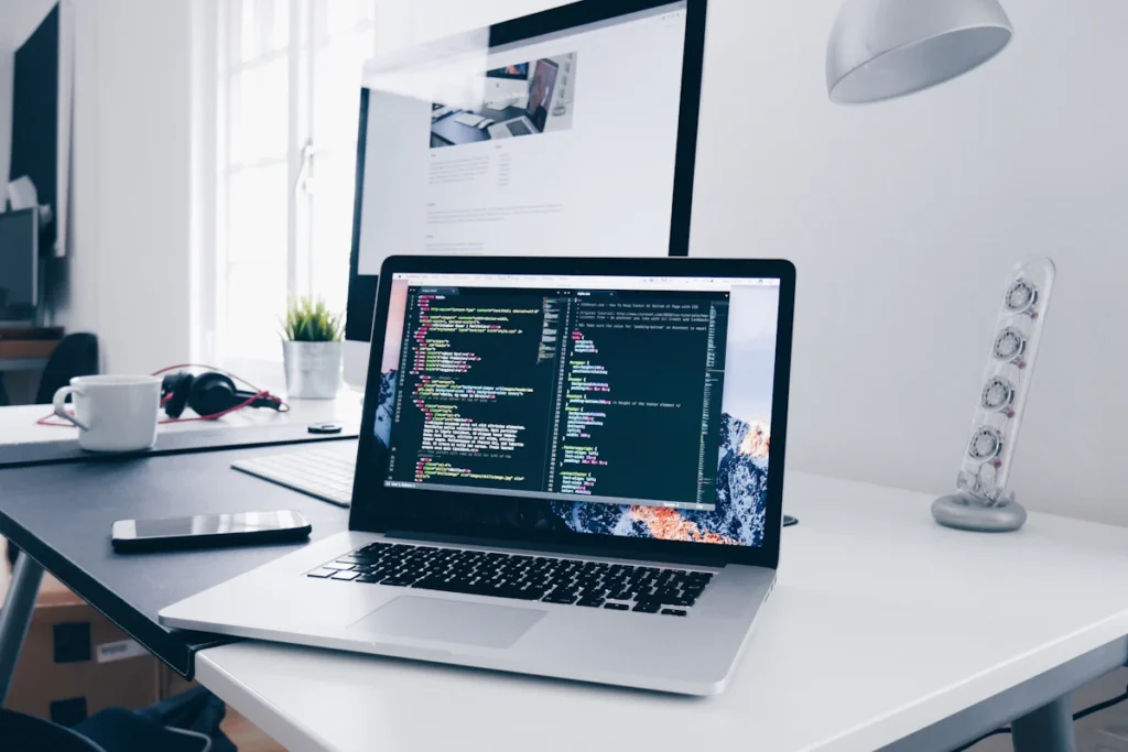 Code displayed on a laptop at a desk