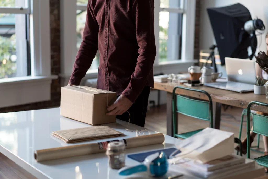 A small business workspace preparing a parcel for shipment