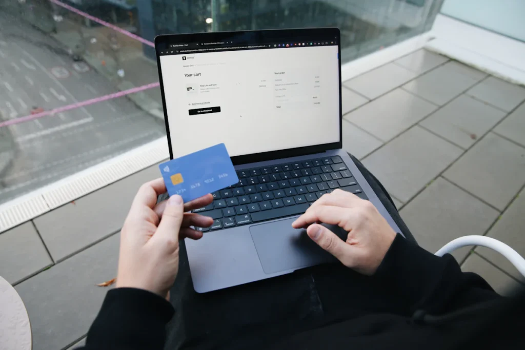 Hands holding a payment card during an online purchase