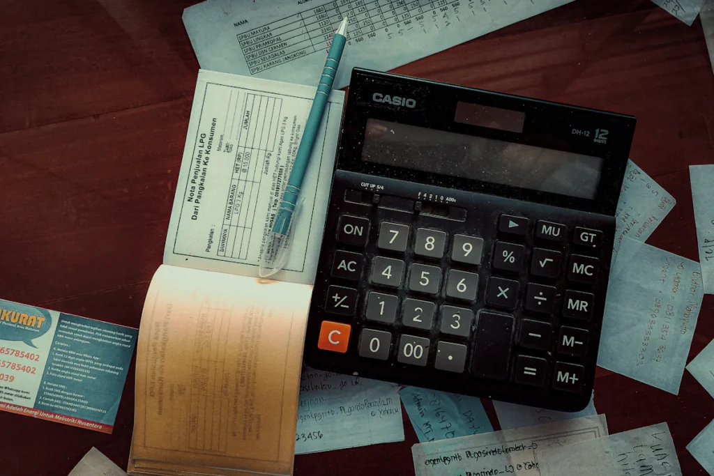 Calculator and paperwork used for ongoing website planning
