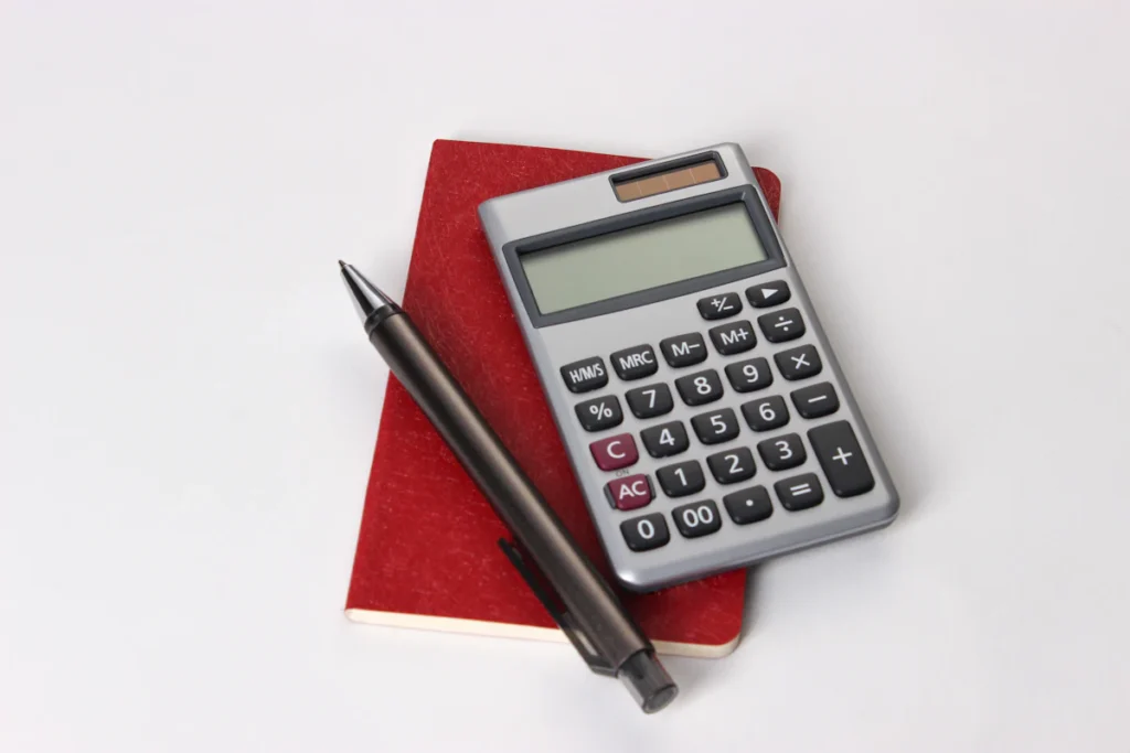 Calculator and notebook used for project budgeting